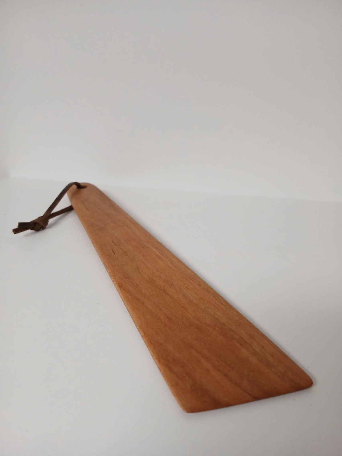 Cherry Flat Spatula finished with beeswax and tied with a leather strand for hanging