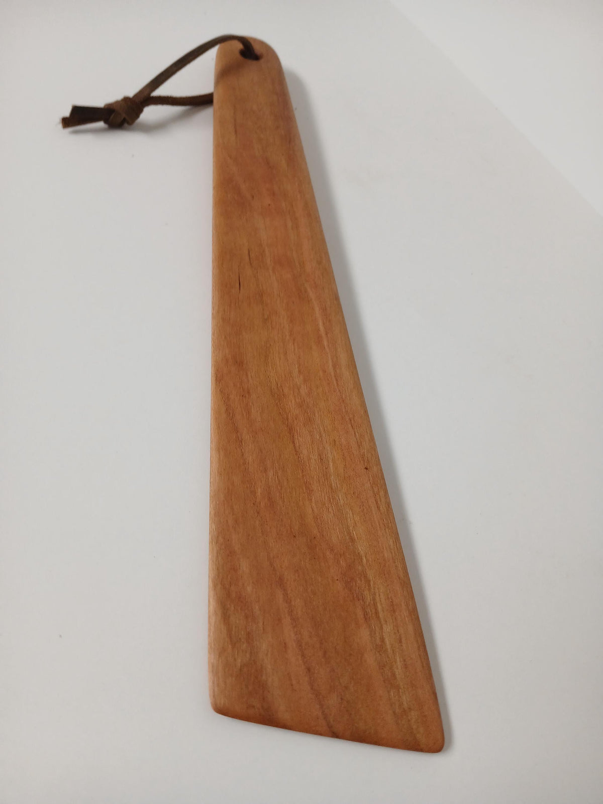Hardwood Cooking Utensil for scraping and turning, handmade and finished with food safe oil and a leather strand. shown from above 