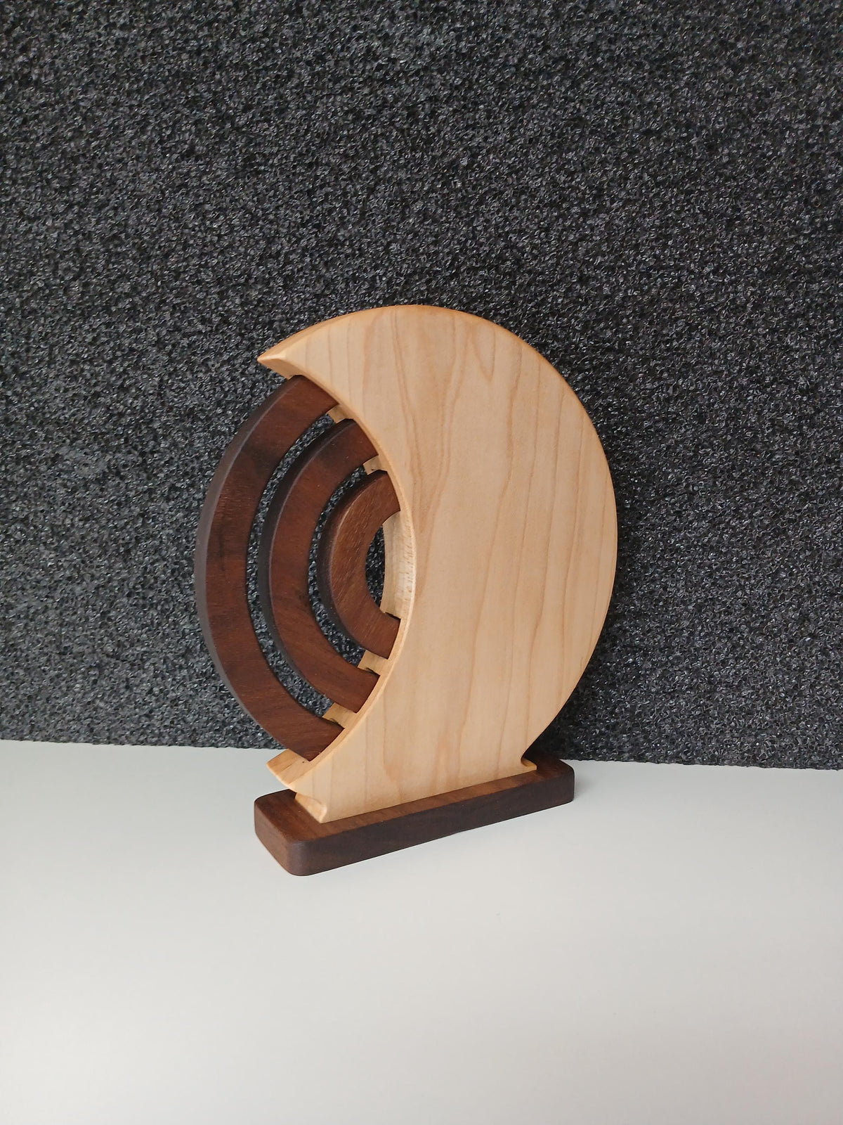 Wooden Perpetual Calendar with Maple shell and walnut rings and base. Beautiful home decor made in Taos New Mexico in the United States. Finished with natural oil and beeswax, viewed from the back side